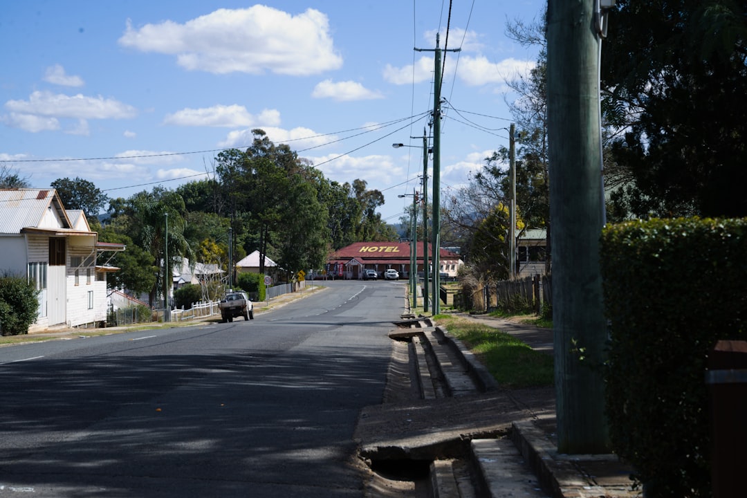 A view of a street with houses and trees